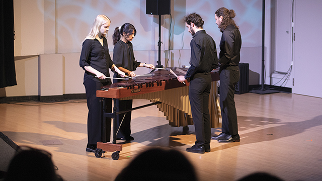 four percussionists playing a marimba