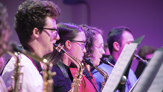 four saxophonists performing on stage