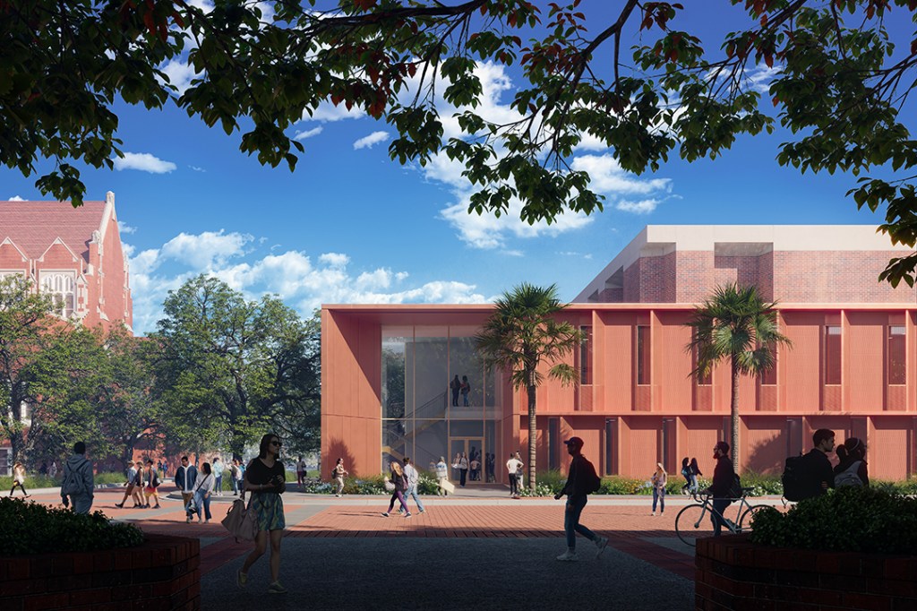 brick building exterior against blue sky showing proposed teaching studios and glass enclosed stairwell