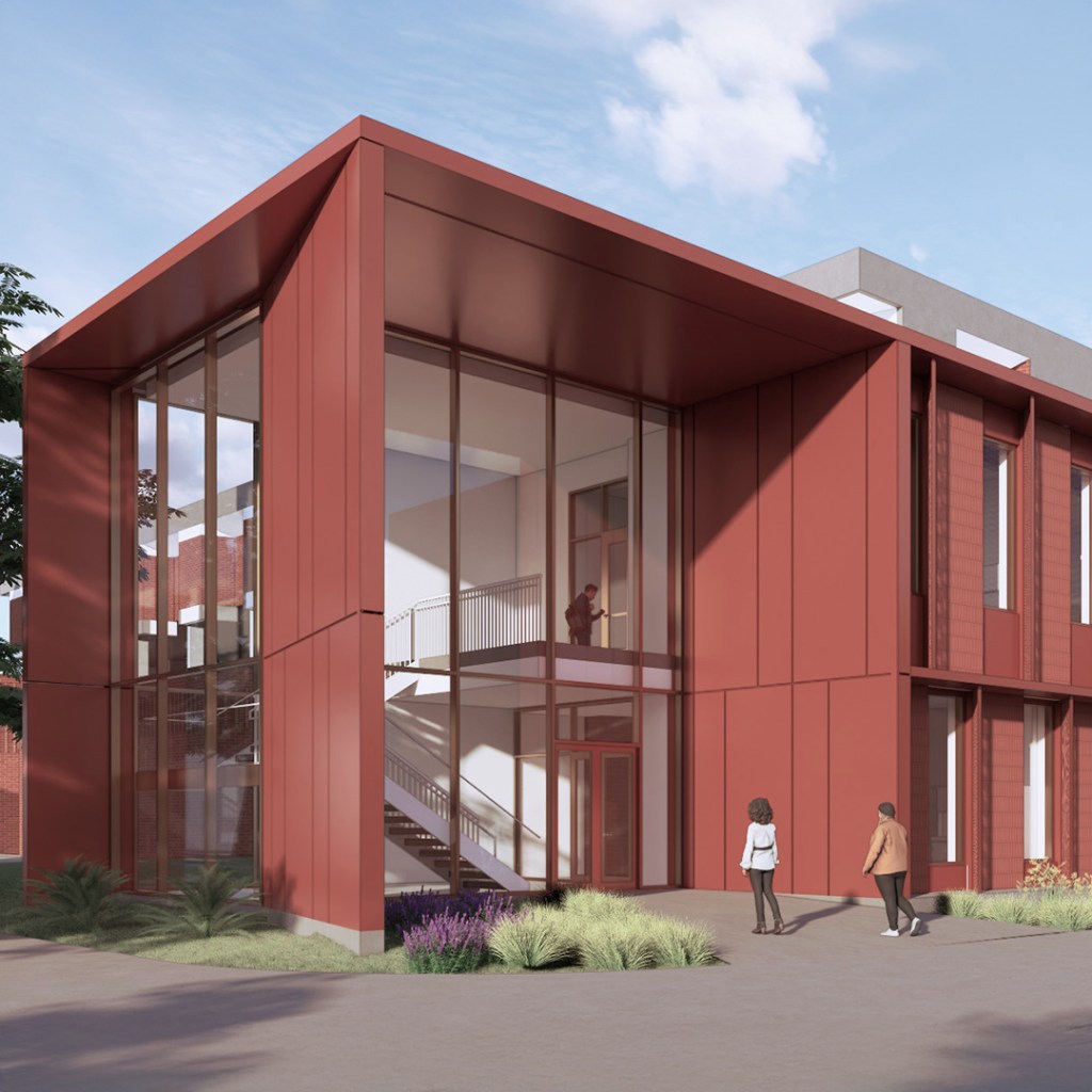 two-story brick facade with stairwell enclosed in glass